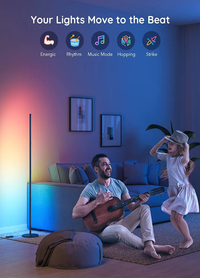 Living room with colorful light therapy lamp and people playing guitar and dancing.