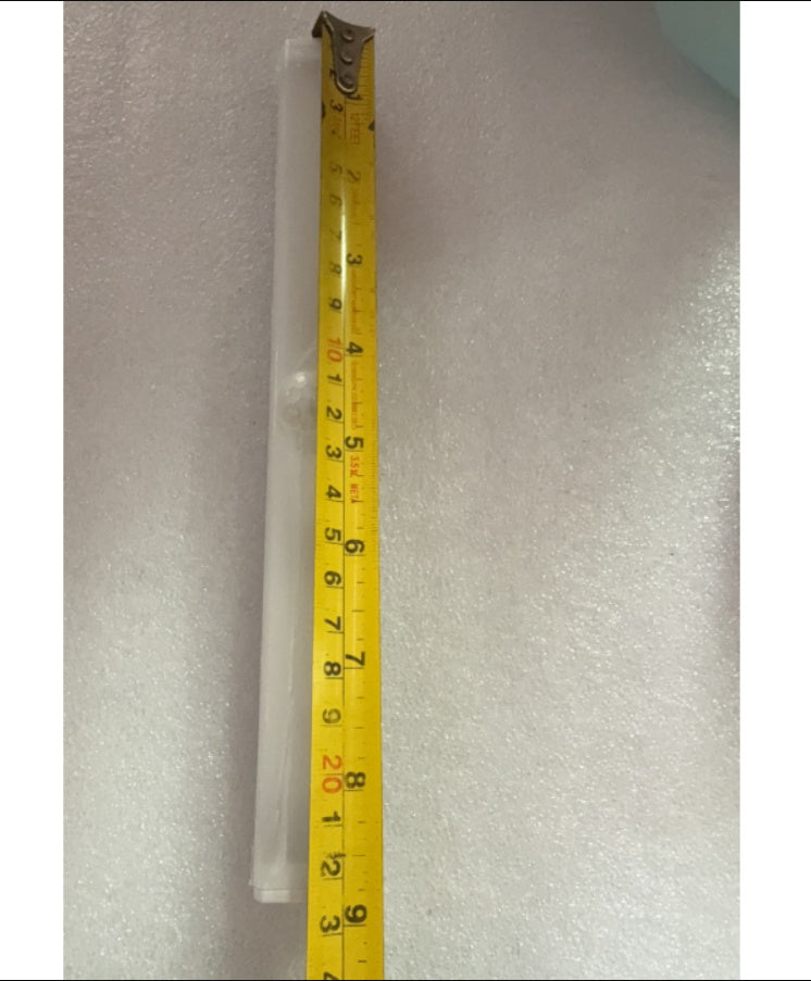 Clear plastic tube with a measuring tape showing its length on a gray background